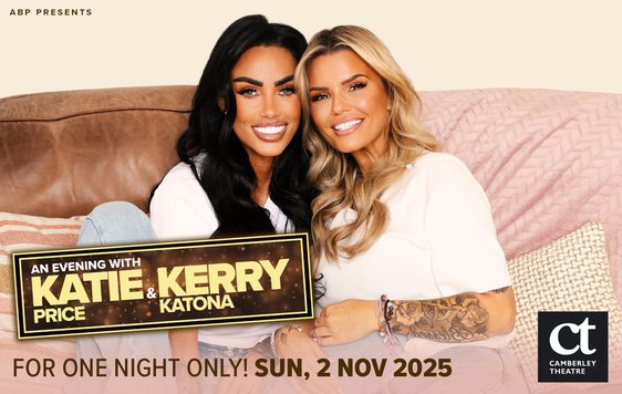 Kate and Kerry leaning into each other sitting on a sofa