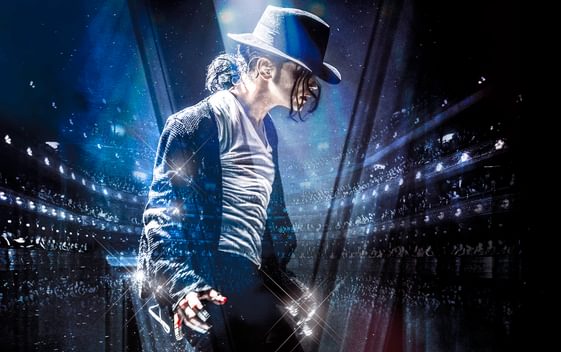 Ben Bowman, dressed as Michael Jackson, poses in profile against a backdrop of stadium lights
