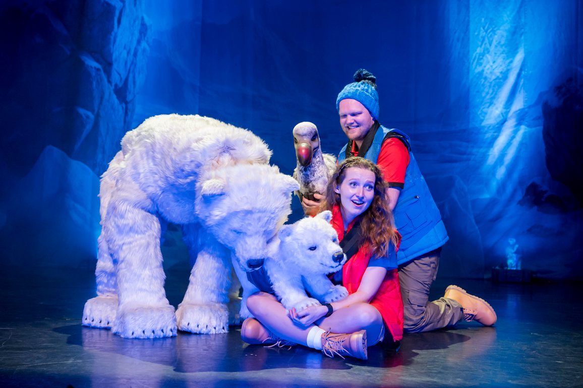 polar bear large puppet and baby cub puppet cast members dressed in bright warm clothes