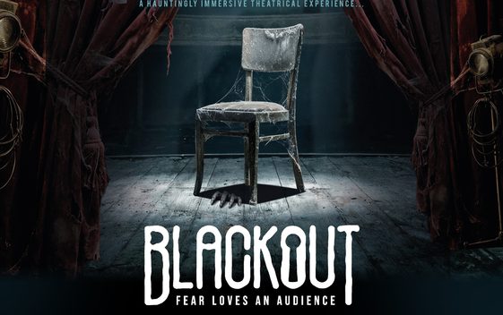 A dusty chair covered in cobwebs sits under a spotlight on an old stage. The show title is shown beneath "Blackout, Fear Loves an Audience".