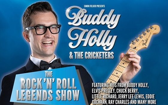 A performer posing as Buddy Holly wearing a black suit and bow tie and holding a guitar. The show title is shown next to him "Buddy Holly & The Cricketers, The Rock 'n' Roll Legends Show"