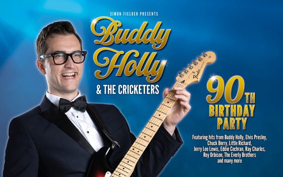 Man dressed in dress suite as 'Buddy' holding guitar with show title in gold writing