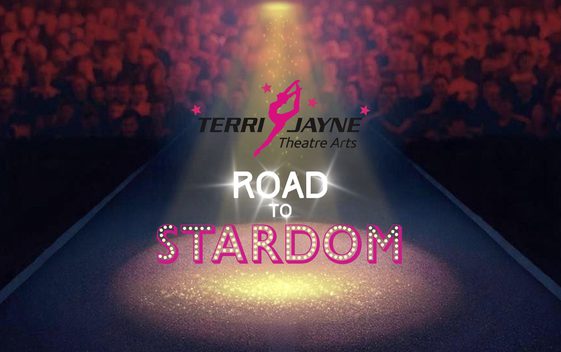 A stage with a spotlight shining over the show title "Road to Stardom" with an audience crowd in the background