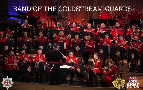 The Band of The Coldstream Guards are performing as a seated orchestra on a stage with a conductor