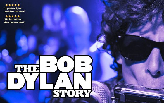 A performer as "Bob Dylan" wearing sunglasses and playing a harmonica ino a microphone. The show title is shown next to him.