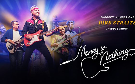 The cast of "Money for Nothing" are shown on stage, playing their instruments and dressed as the members of Dire Straits