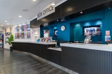 The Box Office counter at Camberley Theatre with leaflets on the counter and posters on the wall
