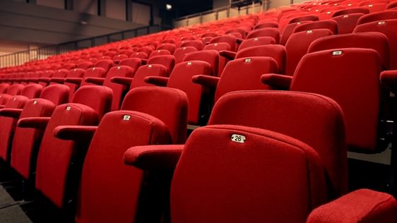 A close-up image of the red auditorium seating at Camberley Theatre