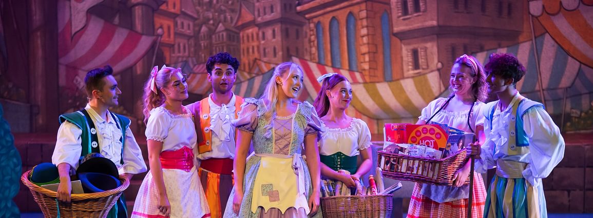 A group of performers on stage in costume