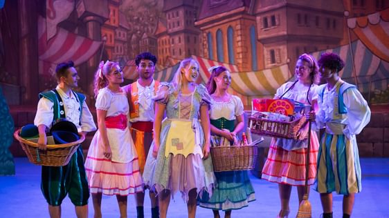 A group of performers on stage in costume