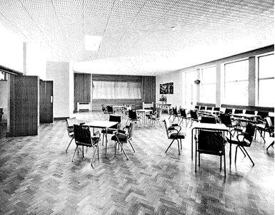A black and white photo showing 'The Lounge' in the Camberley Civic Hall with parquet flooring and tables and chairs